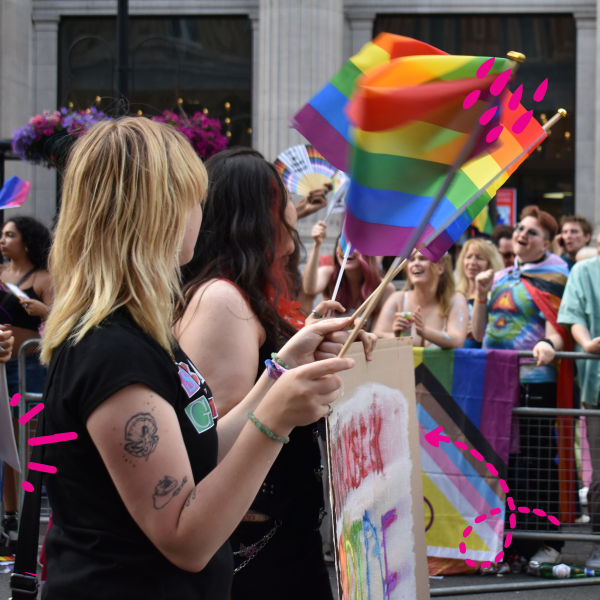Students at Pride with LGBTQ+ Flags