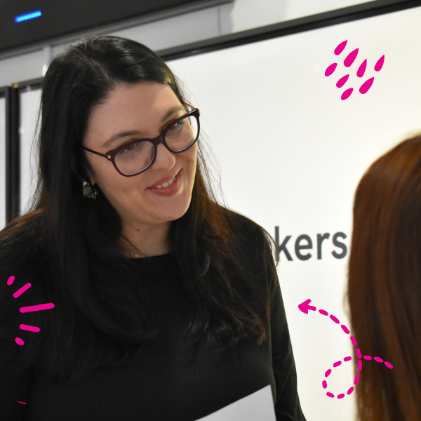 A student smiling at another student